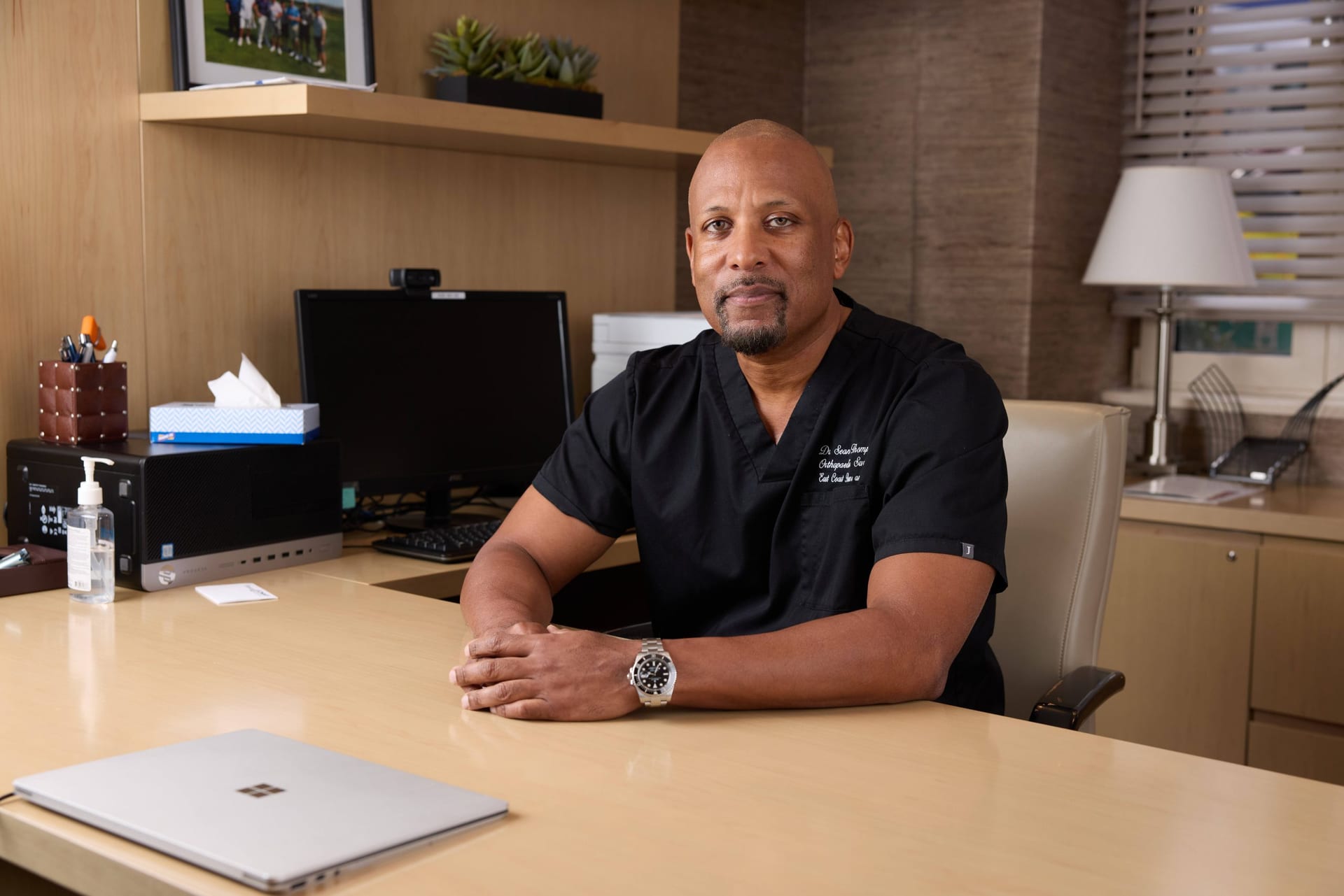 Dr. Sean Thompson at his desk in the practice office
